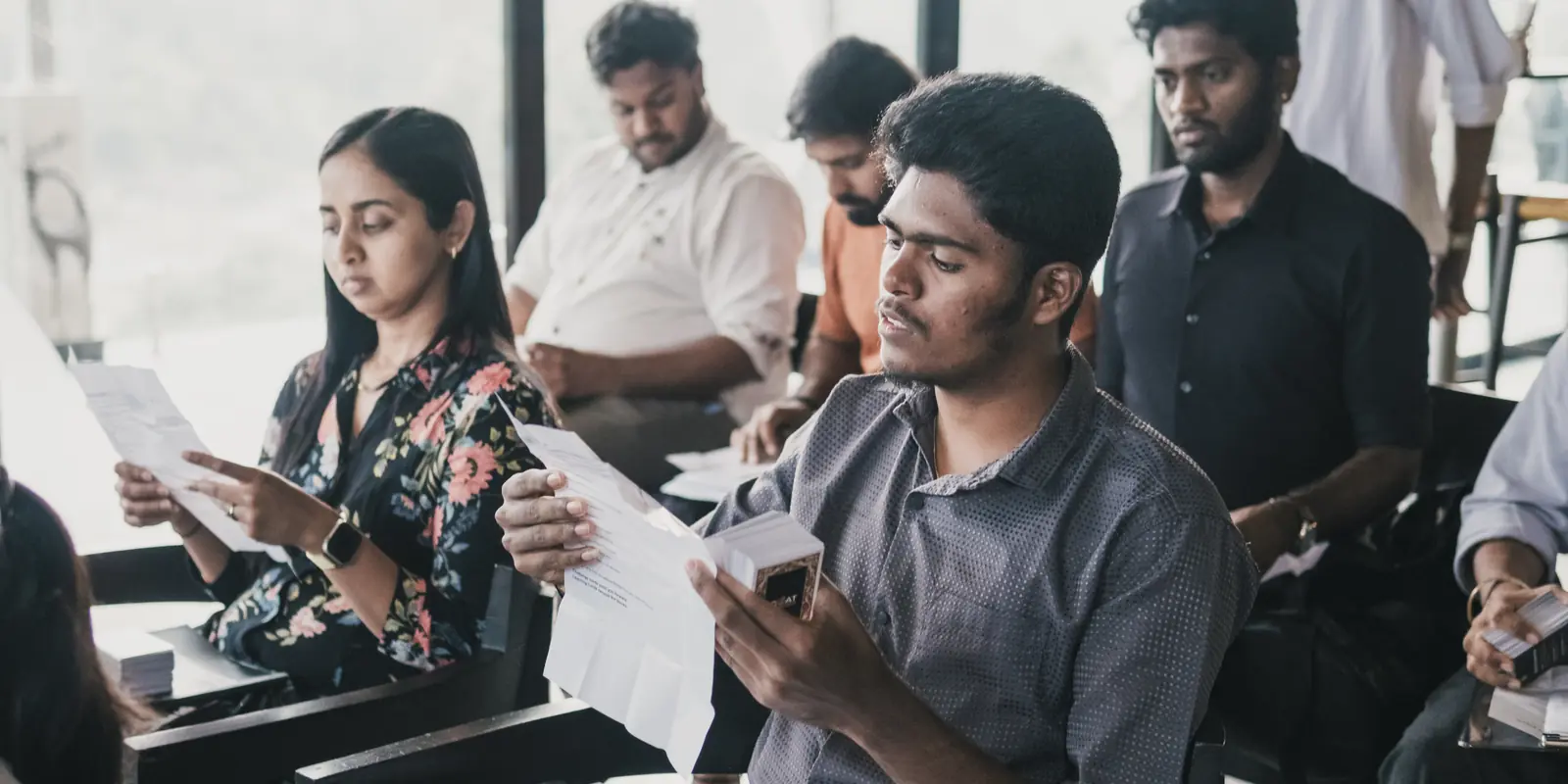 Founders reading through their printed worksheets, exercise cards in hand