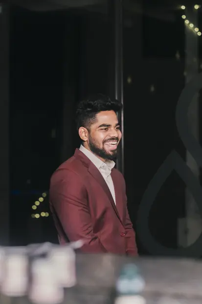 The speaker laughing, caught mid-turn